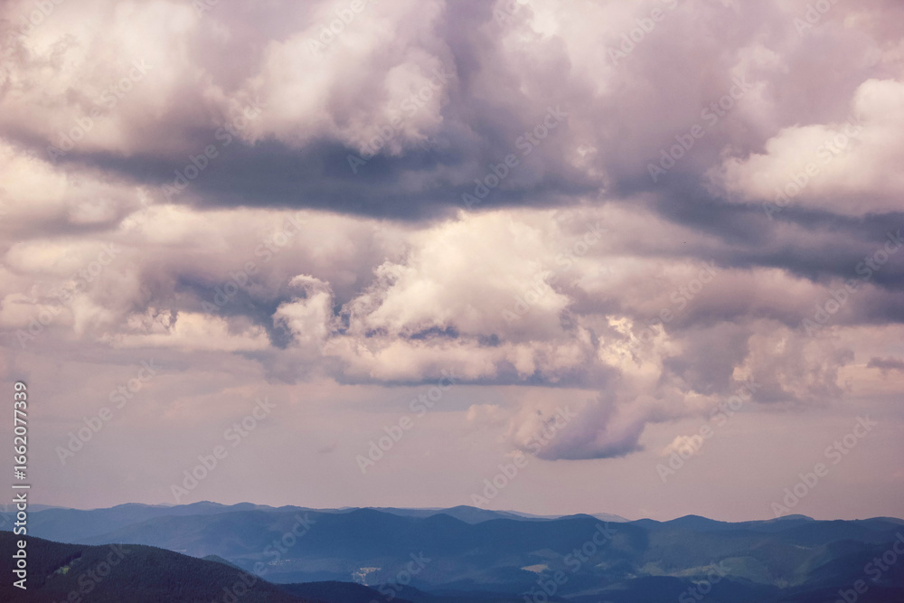 Obraz premium Dramatic clouds over Carpathian mountains, scenic landscape with moody sky and mountain ridges