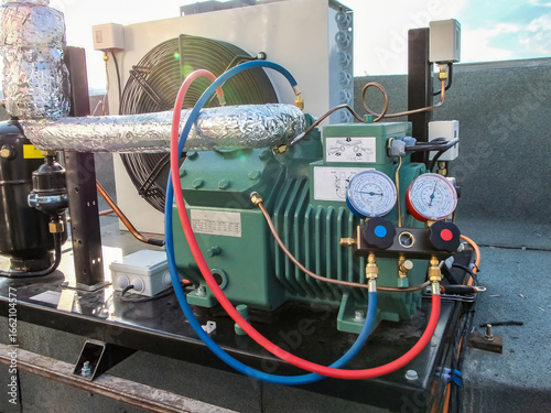 Photography Close-up shot of a commercial refrigeration system showing detailed components and gauges