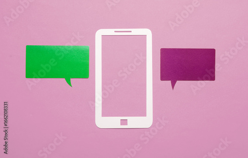 Paper-cut smartphone icon with a speech bubble on a pink background. Social media, online communication