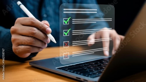 A person uses a stylus to mark items on a digital checklist displayed over a laptop
