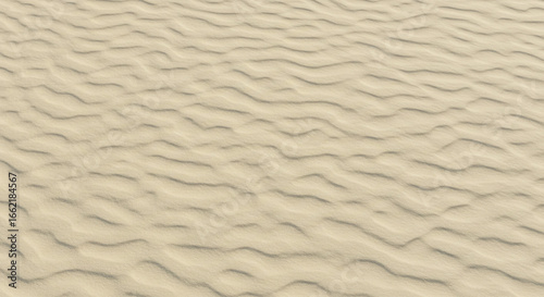 A close up view of a sandy surface with wavy patterns created by wind or water erosion effects