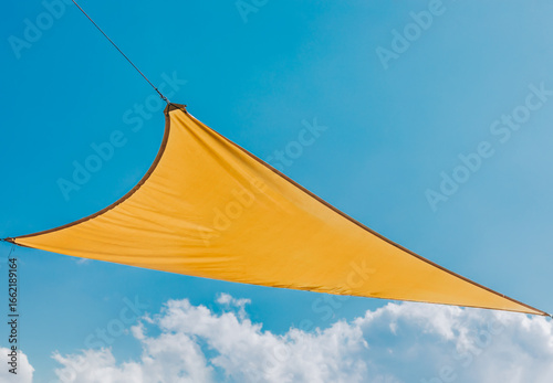 Yellow Shade Sail Against Blue Sky