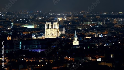 Wallpaper Mural Paris, France. A nighttime cityscape with a focus on the NotreDame Cathedral. The city is illuminated with a myriad of lights, creating a warm, golden glow against the dark sky. Torontodigital.ca