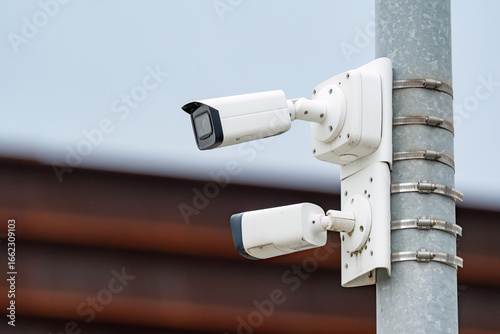 2 security cameras mounted on the pole