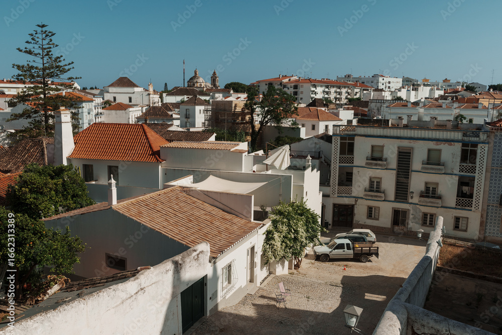Obraz premium View of Faro old town with tiled roofs and dome of Igreja do Carmo, Algarve, Portugal