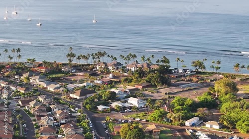 Aerial view of coastal town Lahaina, Maui, Hawaii not affected by wildfire with homes along ocean coast waves and palm trees landscape seascape - 4K Drone