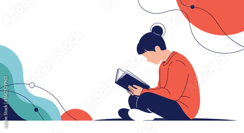 A young person is reading a book while sitting down, absorbed in the story, enjoying their quiet time