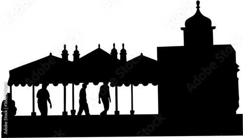Silhouette of people under a covered walkway adjacent to a building with a domed tower structure