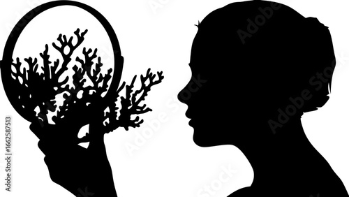 Silhouette of a woman looking at a coral branch held in a circular frame in black and white tones