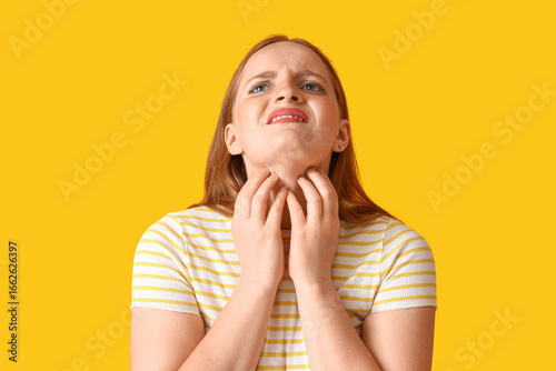 Allergic young woman scratc...
