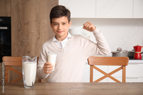 Young boy flexing bicep wit...
