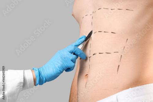 Plastic surgeon with scalpe...