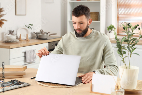 Young bearded man opening l...