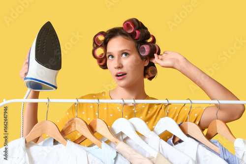 Young woman holding iron ne...
