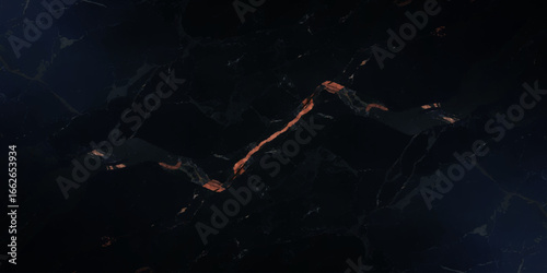 Luxurious marble texture with a predominantly black background and flowing patterns with golden veins running through it, creating a striking contrast.	