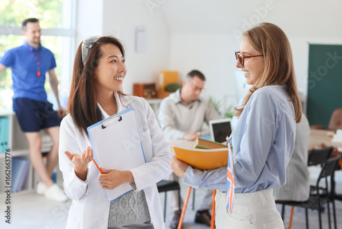 Female teachers talking in ...