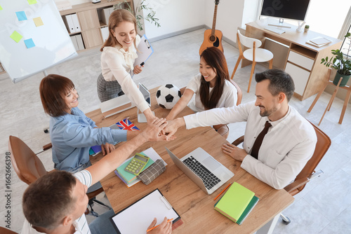 Group of teachers putting h...