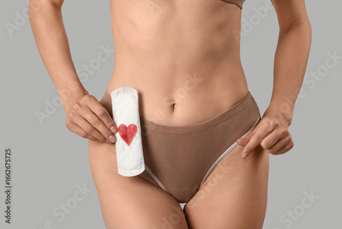 Young woman in panties hold...