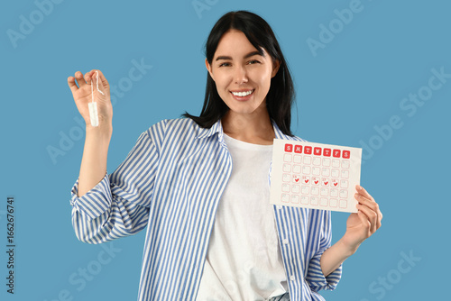 Young woman with tampon and...