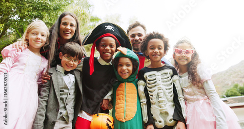 Halloween, outdoor and portrait with parents, kids and celebration with happiness, tradition and smile. Group, friends and children in backyard, costume party and fun with fantasy, trick and treat