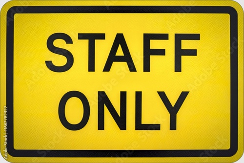a bright yellow sign with a  text STAFF ONLY