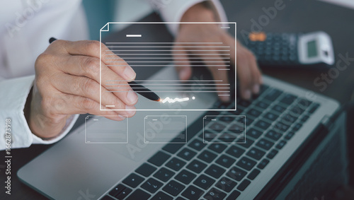 Businessman digitally signing a document with a stylus over a laptop keyboard, the concept of electronic signatures, paperless transactions, and modern online agreements. Digital transformation.