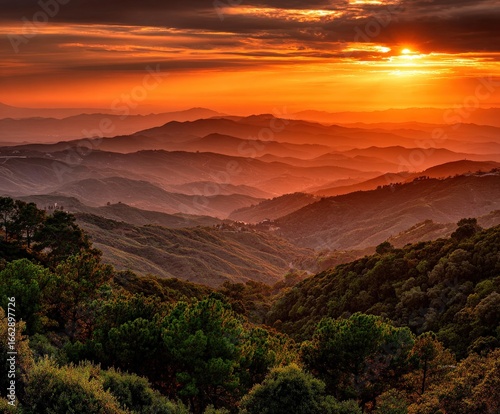 Mountains bathed in warm sunset light over valleys