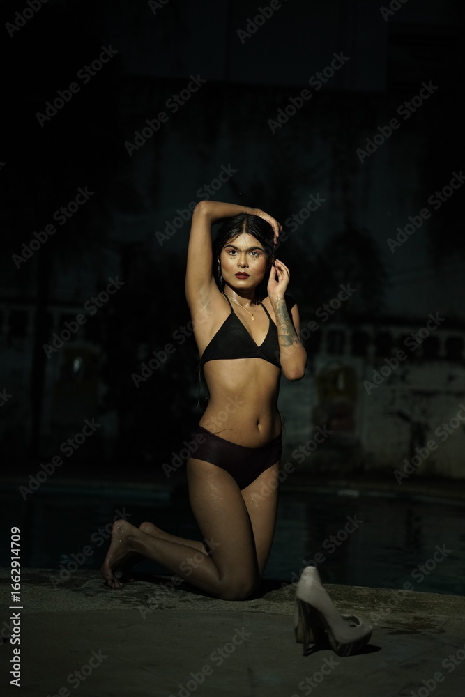 Obraz premium Woman in Bikini Kneeling by Poolside, Summer Swimwear Pose