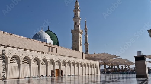 Pan up of green and silver dome of Nabawi mosque in Medina, Saudi Arabia. 