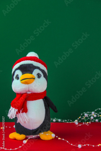 Christmas penguin on red green background.