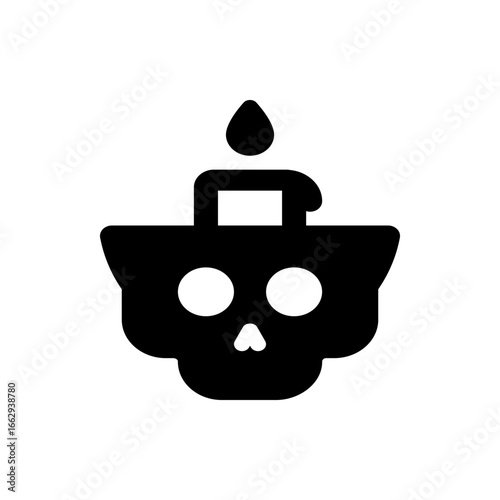 Black skull shaped container with two white circles and a candle on top with a drop of wax, isolated