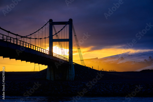 Landscape view of Suspension bridge building with car driving over Jokulsarlon glacier lagoon with sunset skyline in autumn season Iceland