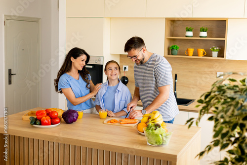 Family cooking together in ...