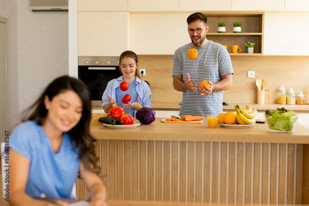 © BGStock72 - Joyful moments of cooking and juggling with friends in a sunny kitchen