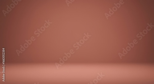 An empty studio room with a dusty rose colored seamless backdrop, softly lit for product display or presentation.