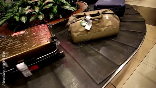 Close-up view of people receiving baggage from conveyor belt at airport after flight USA conveyor belt of terminal airport. 4K background