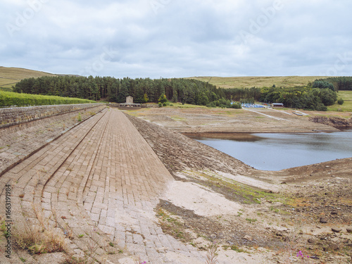 Views of Errwod Reservoir in Derbyshire, UK, showing extremely low water levels during a summer heatwave