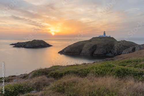 Strumble Head Lighthouse on the Pembrokeshire Coast in Wales at sunset