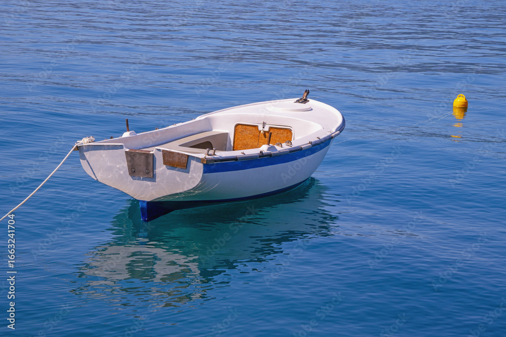 Naklejka premium Fishing boat on calm water on sunny day, background