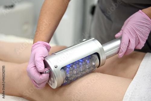 Endospheric device on a woman in a modern clinic. Deep cellulite reduction, professional endospheric massage therapy session in a modern clinic, body contour correction, skin rejuvenation.