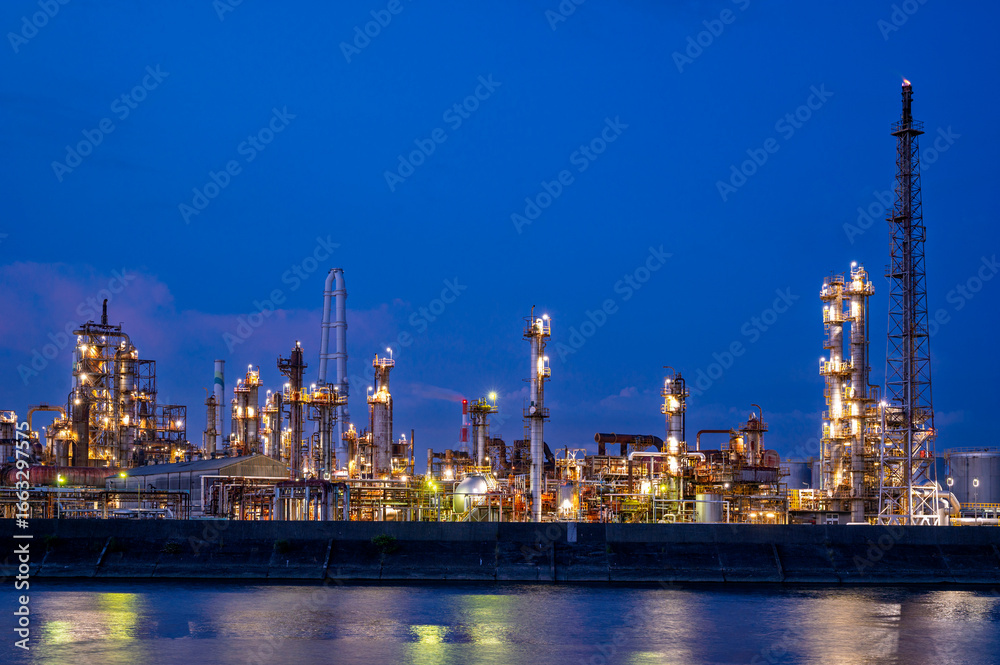 Naklejka premium Yokkaichi industrial Japan factory area with blue twilight sunset sky background view Yokkaichi, Mie Prefecture, Japan.