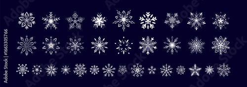 Set of white chalk snow flake drawings of dark blue blackboard. Childish crayon, pencil, pastel whimsical scribbles. Winter Merry Christmas and Happy New Year design elements. Fancy ice frozen symbols
