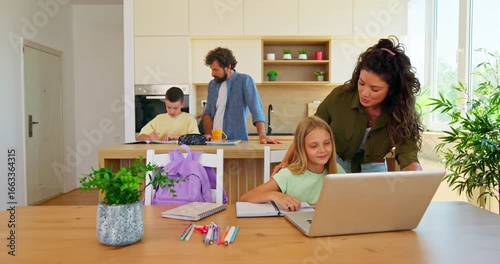Family enjoying time together doing homework and homeschooling with computer 