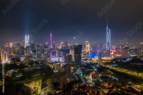 Urban sprawl unfolds beneath a canopy of night lights