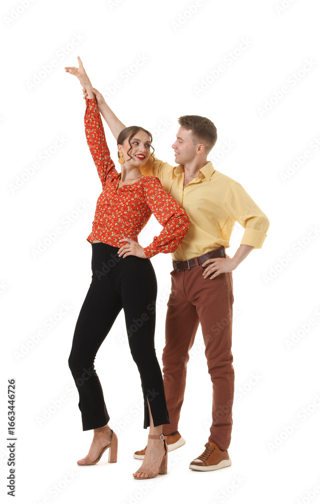 Fototapeta premium Happy couple in retro outfits dancing on white background