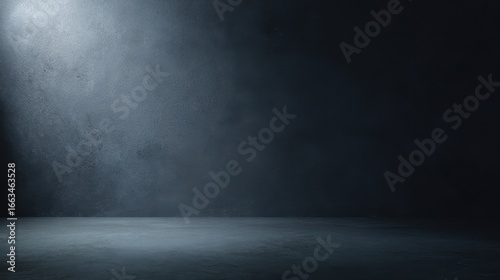 The empty dark space illuminated with dramatic lighting and textural elements.