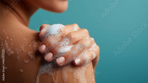 Woman washing soaped her body with a foam. Daily skincare routine, Cleansing concept
