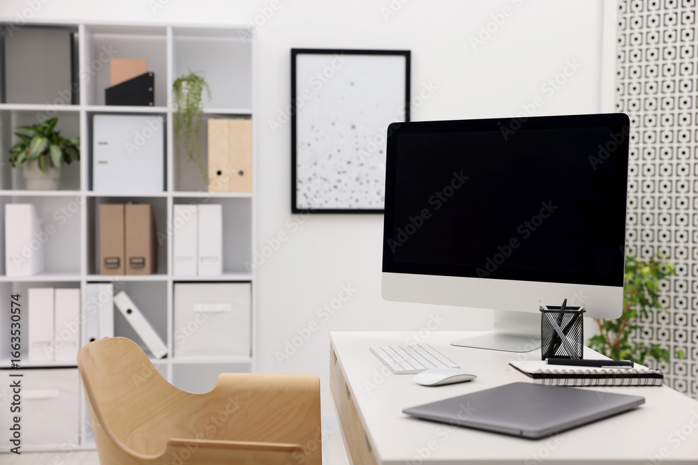 Fototapeta premium Stylish workplace with modern computer, laptop and stationery on white table in office