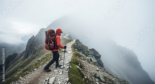 Adventurous hiker with backpack standing in foggy mountains, perfect for outdoor exploration, travel inspiration, wilderness photography, and nature adventure themes.