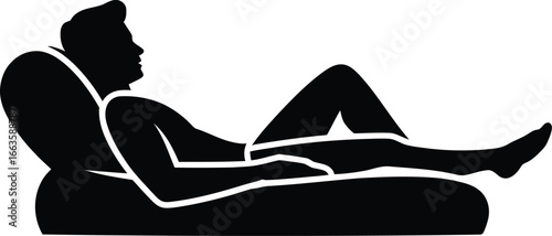 Silhouette of a man relaxing in a recliner chair with legs extended
